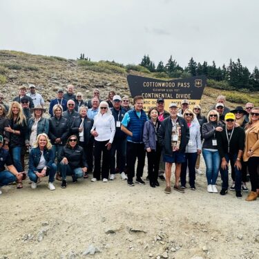 Peak to Peak Rallye participants in front of Cottonwood Pass sign