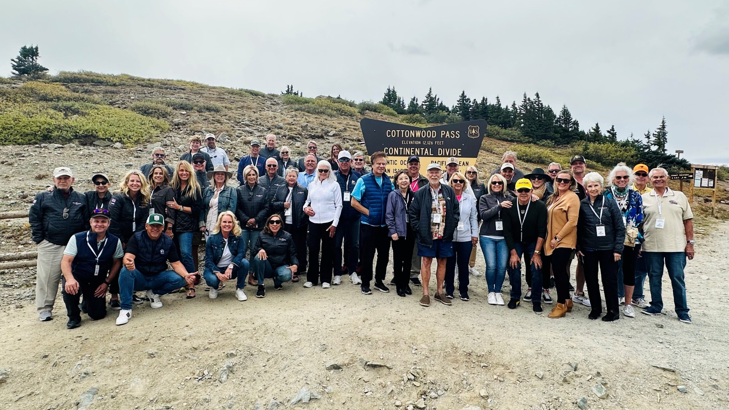 Peak to Peak Rallye participants in front of Cottonwood Pass sign
