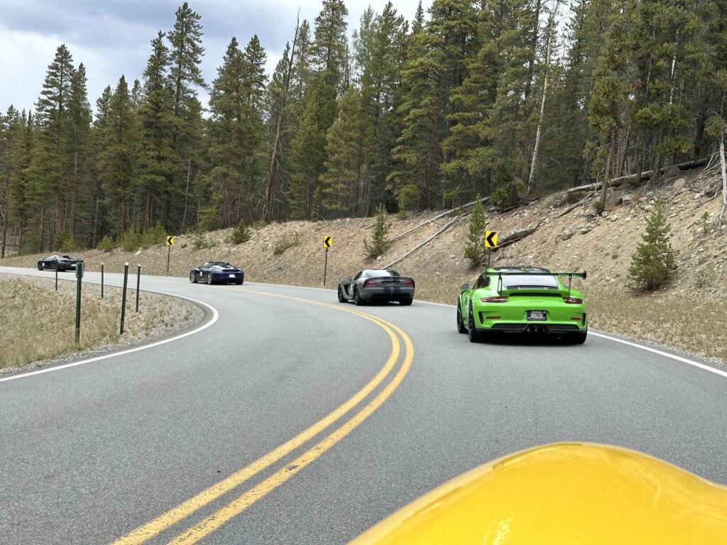 Peak to Peak Rallye - Several sports cars driving around corner