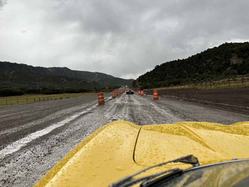 Peak to Peak Rallye - Yellow sports car driving in the rain